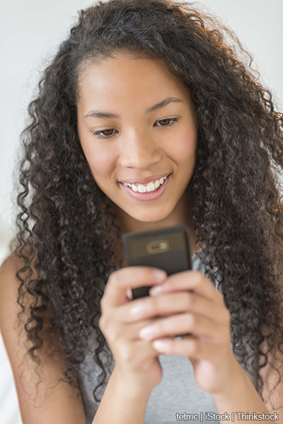 A photo shows a girl texting on a smart phone
