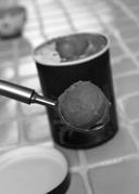 The image shows a photograph of ice cream being scooped from a pint container.